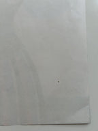 White paper with a small black mark on a white background