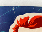 Close-up of a vintage-style poster with a red and white design on a blue background.