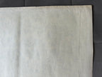 Close-up of a textured beige fabric on a dark background