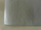 Sheet of white paper on a beige surface