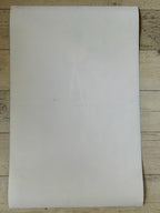 White sheet of paper on a wooden surface