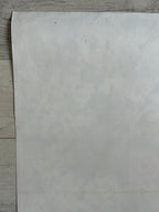Sheet of white paper on a wooden surface