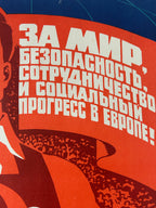 Soviet-style propaganda poster with text and abstract design on a red background