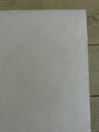 White sheet of paper on a wooden surface