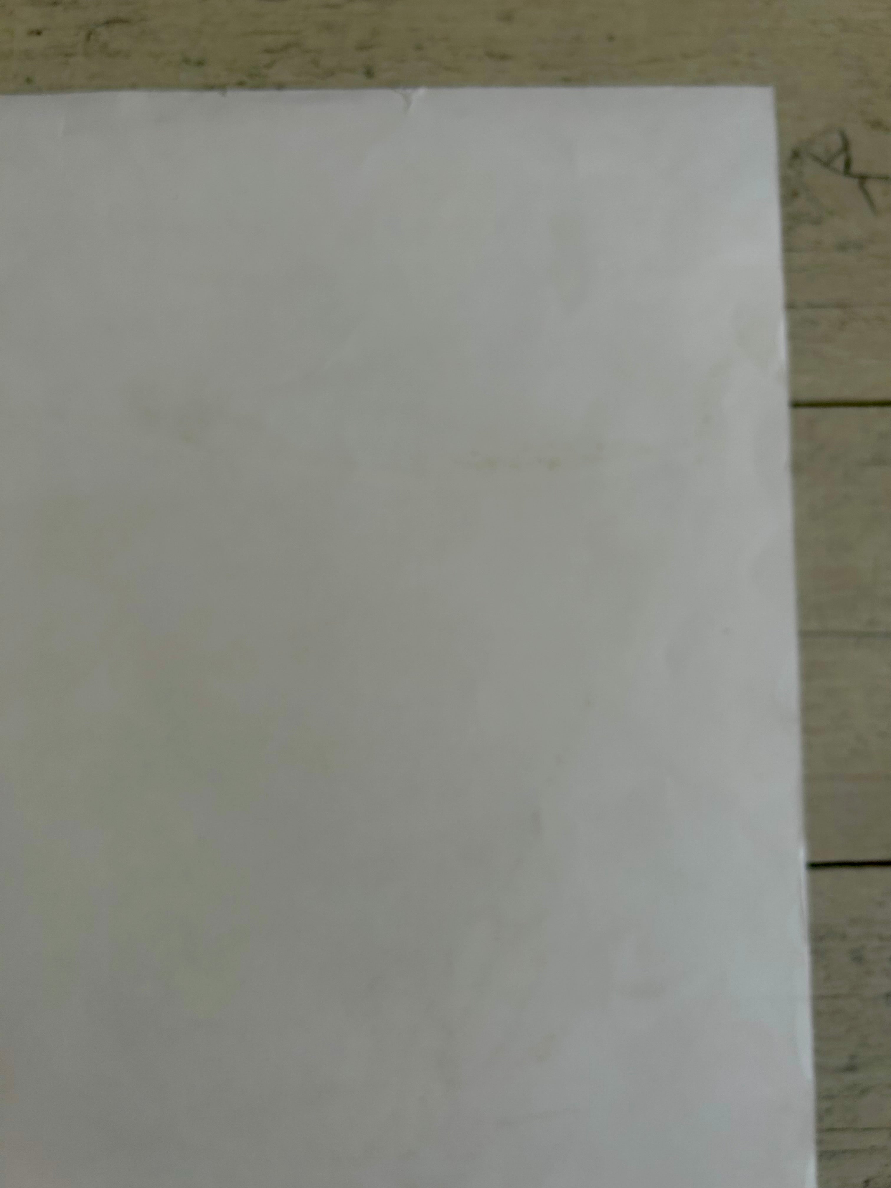 White sheet of paper on a wooden surface
