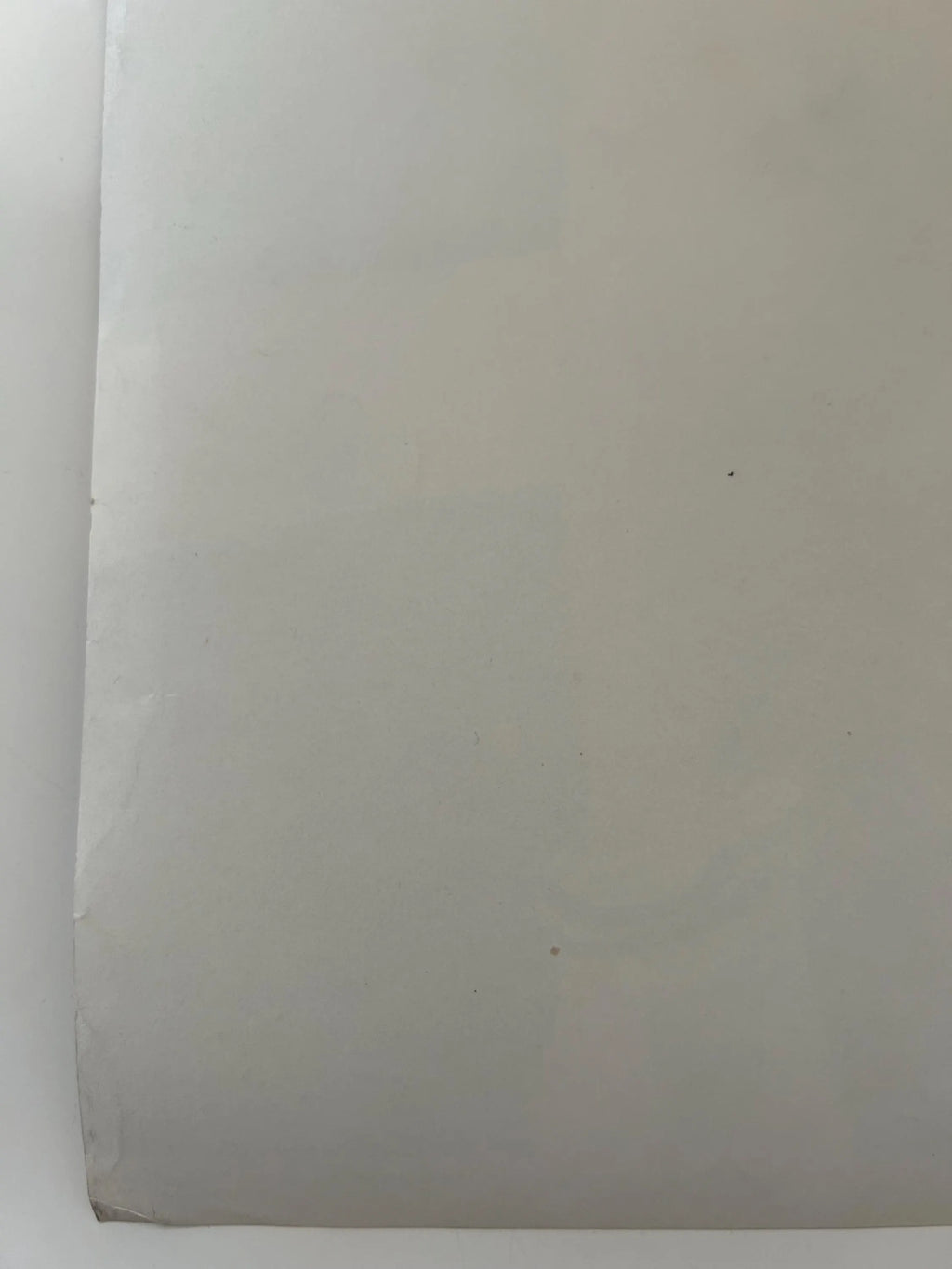 Plain white sheet of paper on a white background