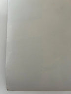 Plain white sheet of paper on a white background