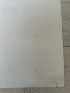 White sheet of paper on a wooden surface