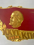  gold embossed face  of Lenin and text on a red background