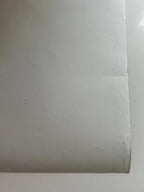 Close-up of a roll of white paper on a white background