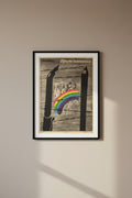 Collage with barbed wire, pencils, and a rainbow over a black and white photo of people.