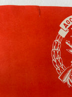 Red paper with a white emblem and text on a white background
