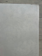 Sheet of white paper on a wooden surface