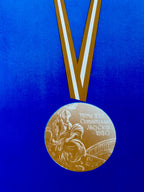 a medal with a ribbon on a blue background