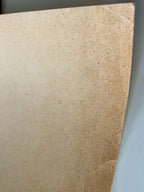 Close-up of a beige paper with a textured surface