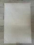 Large sheet of white paper on a wooden surface