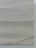Close-up of a textured beige paper with visible folds on a white background