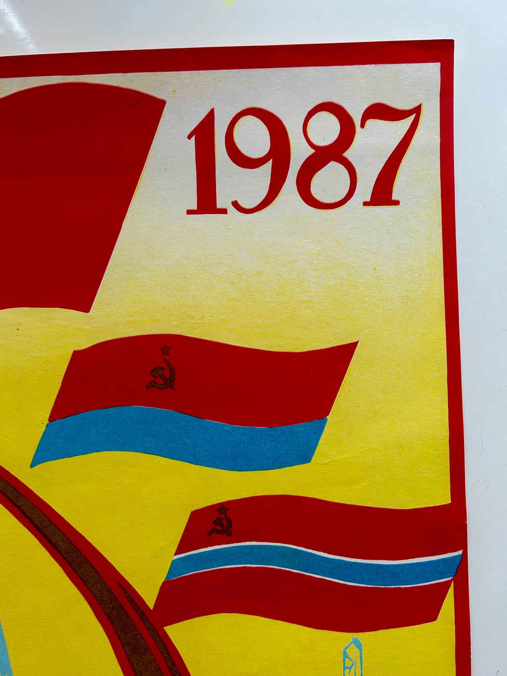 Poster with '1987' text and flags on a yellow background