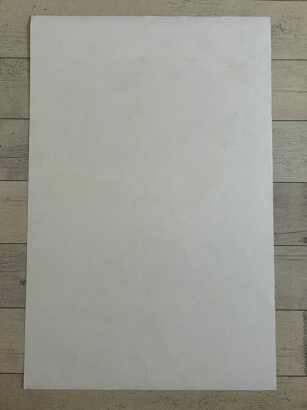 White sheet of paper on a wooden surface