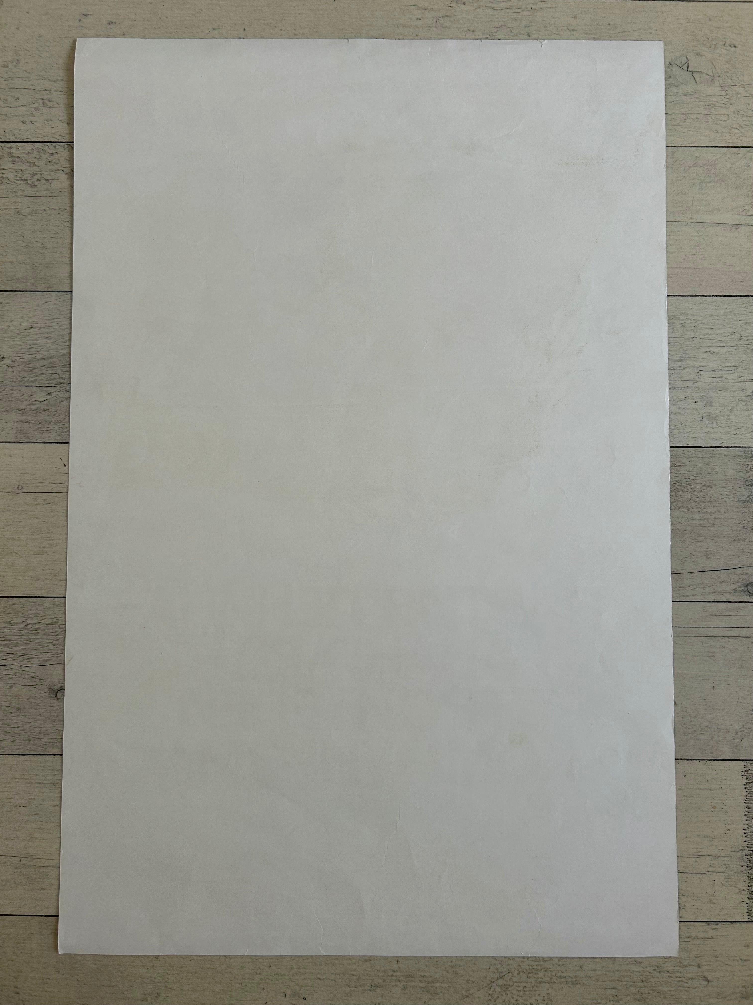 White sheet of paper on a wooden surface