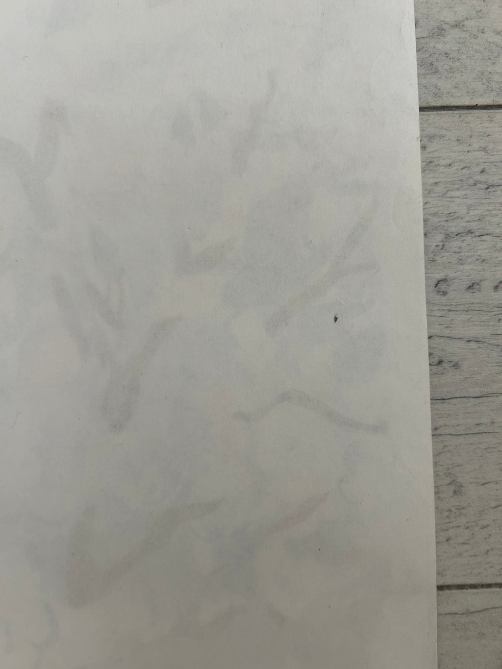 White paper on a light gray tiled floor.
