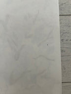White paper on a light gray tiled floor.