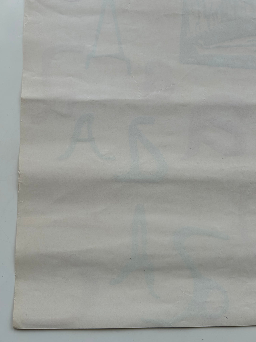 Textured gray paper with a subtle pattern on a light gray background