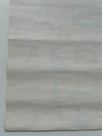 Textured gray paper with a subtle pattern on a light gray background