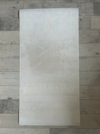 White rectangular sheet on a wooden floor