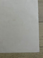 White sheet of paper on a wooden surface