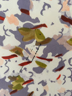 Close-up of a pattern with green, brown, and red colors on a white background.