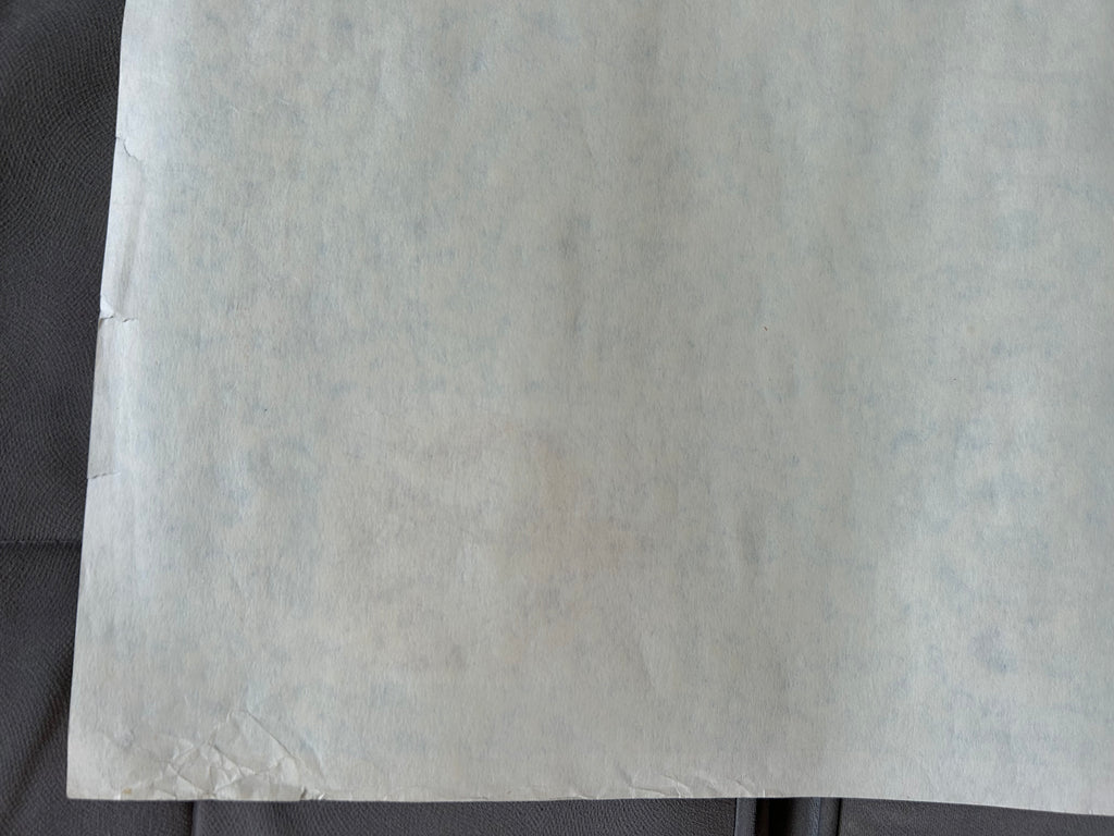 Close-up of a textured white sheet on a dark background