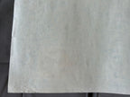 Close-up of a textured white sheet on a dark background