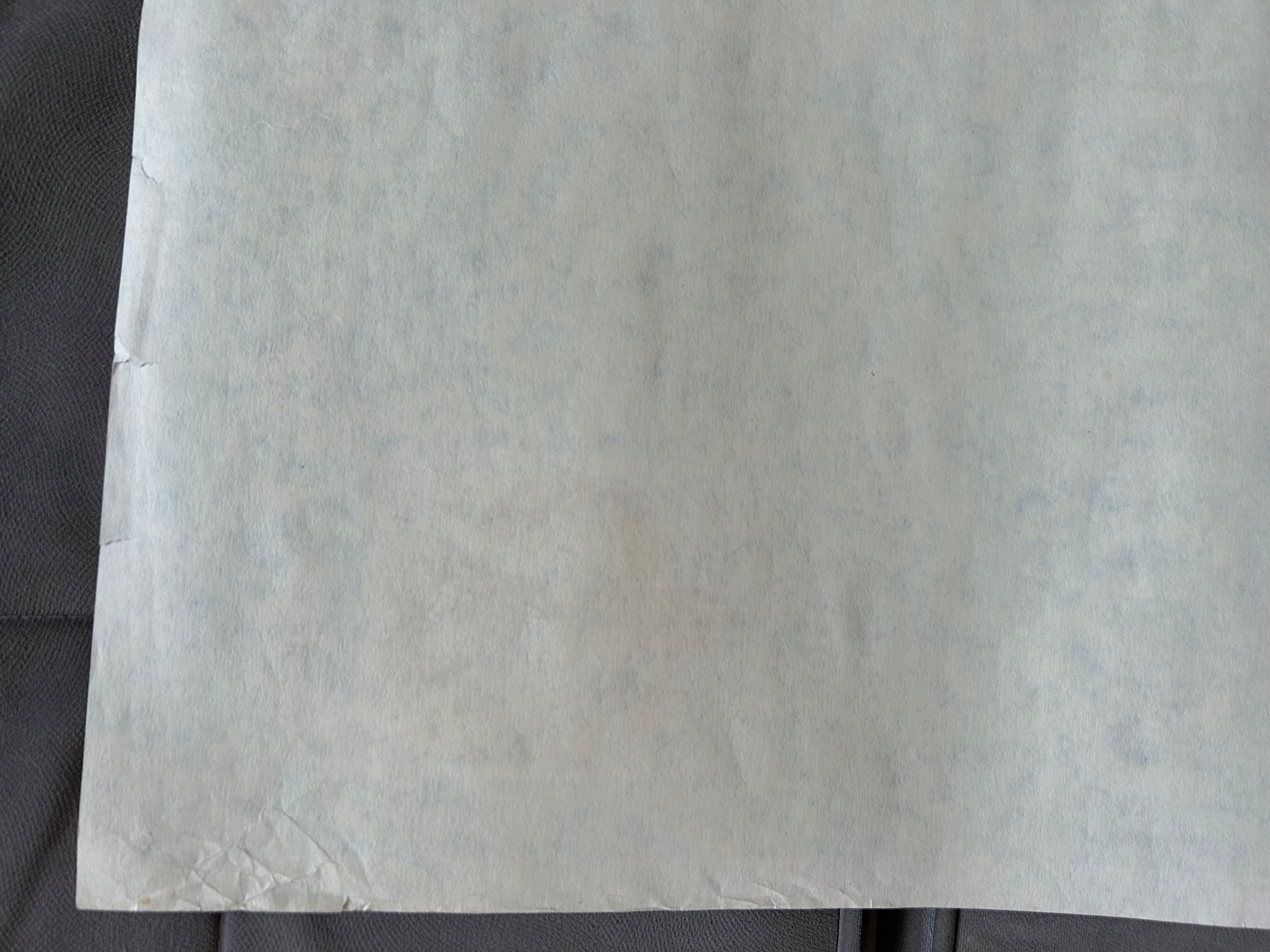 Close-up of a textured white sheet on a dark background
