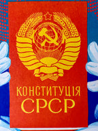 Book cover (USSR Constitution) with a yellow emblem and text on a red background