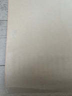 Beige textured paper on a wooden surface