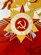 Decorative mil;itary emblem with hammer and sickle symbol on a red background