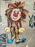 Cartoon clown character with a checkered outfit on a textured background