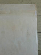 Sheet of plain white paper on a wooden surface