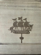 Decorative ship silhouette on a textured surface