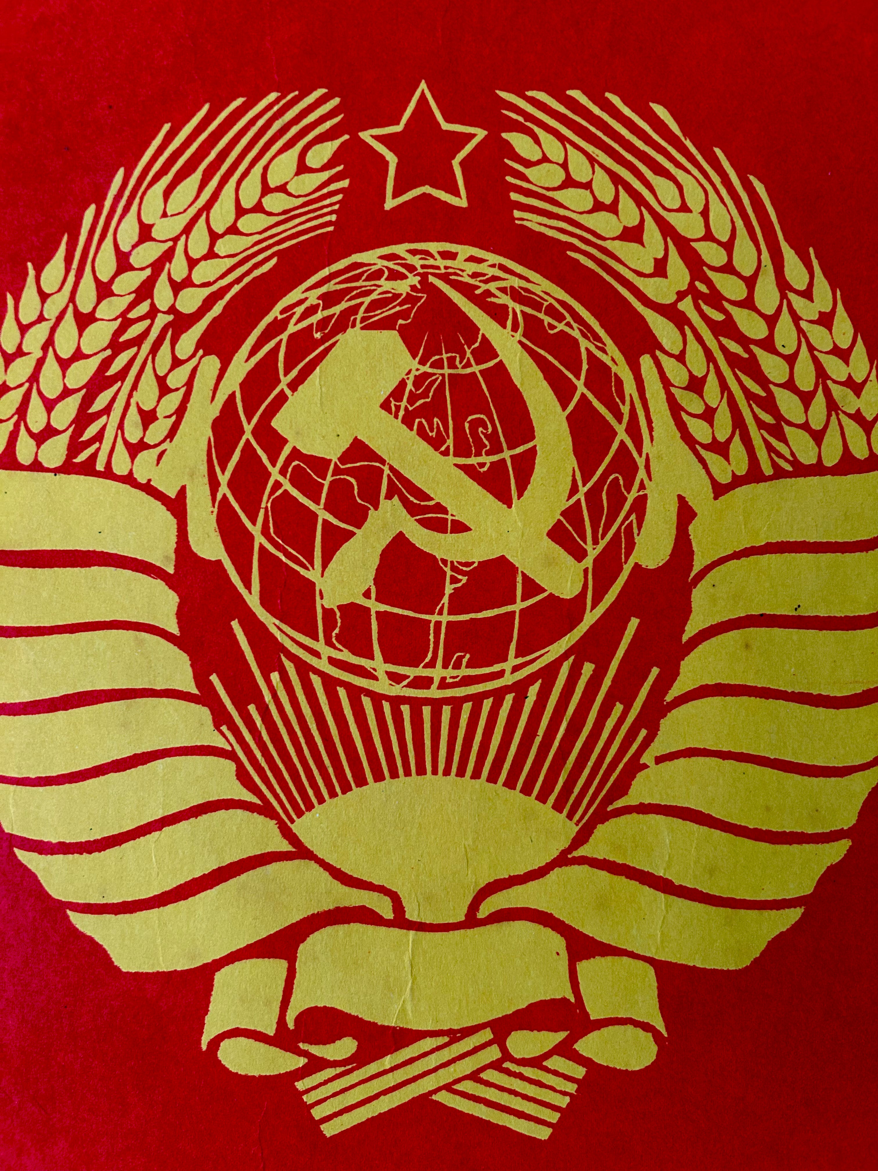 USSR Coat of arms with hammer and sickle on a red background
