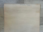 Large piece of brown paper with text on a wooden surface