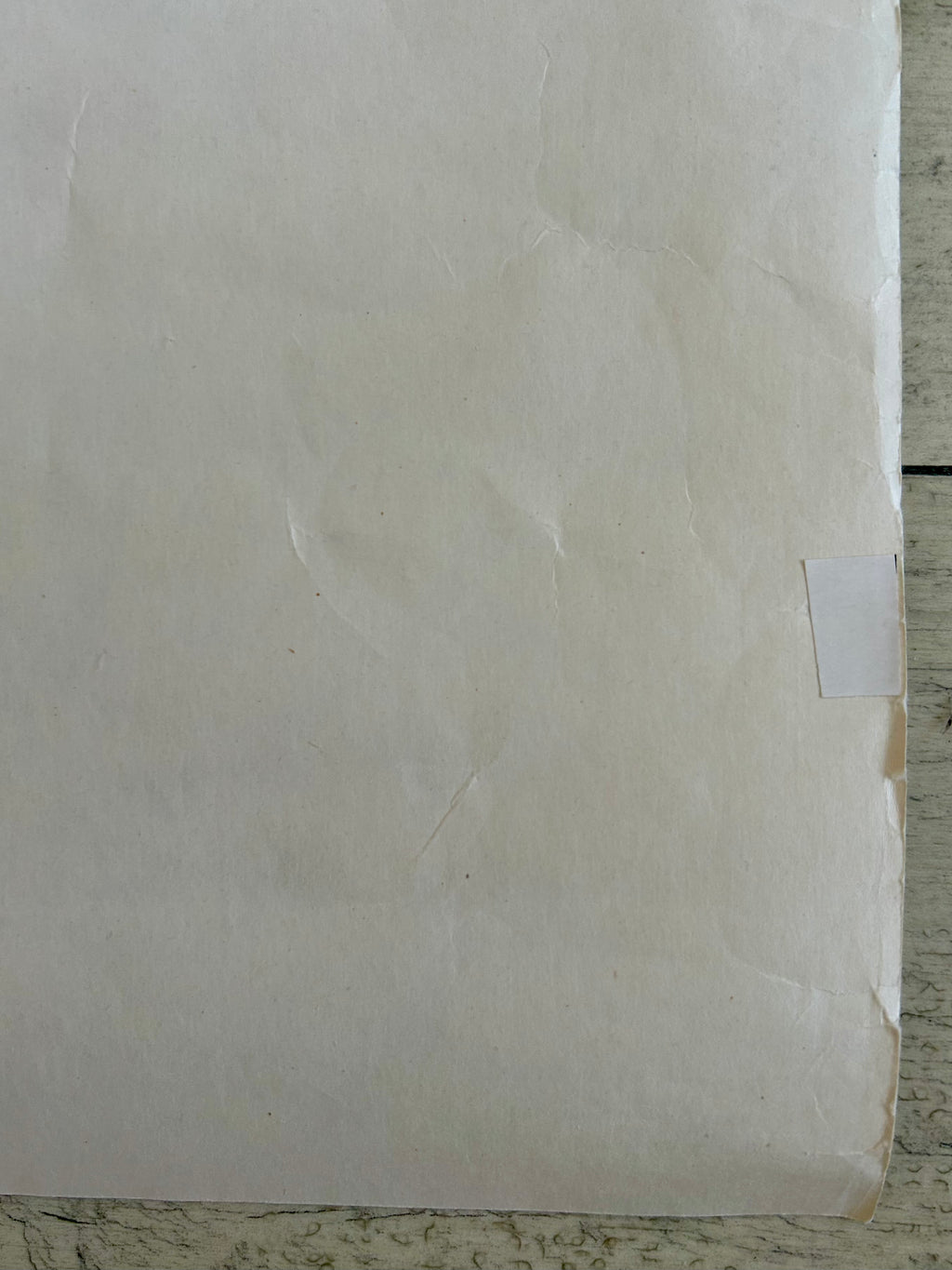 Close-up of a textured beige surface with a small square cutout.