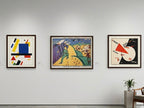 Three abstract artworks on a wall in an art gallery setting.