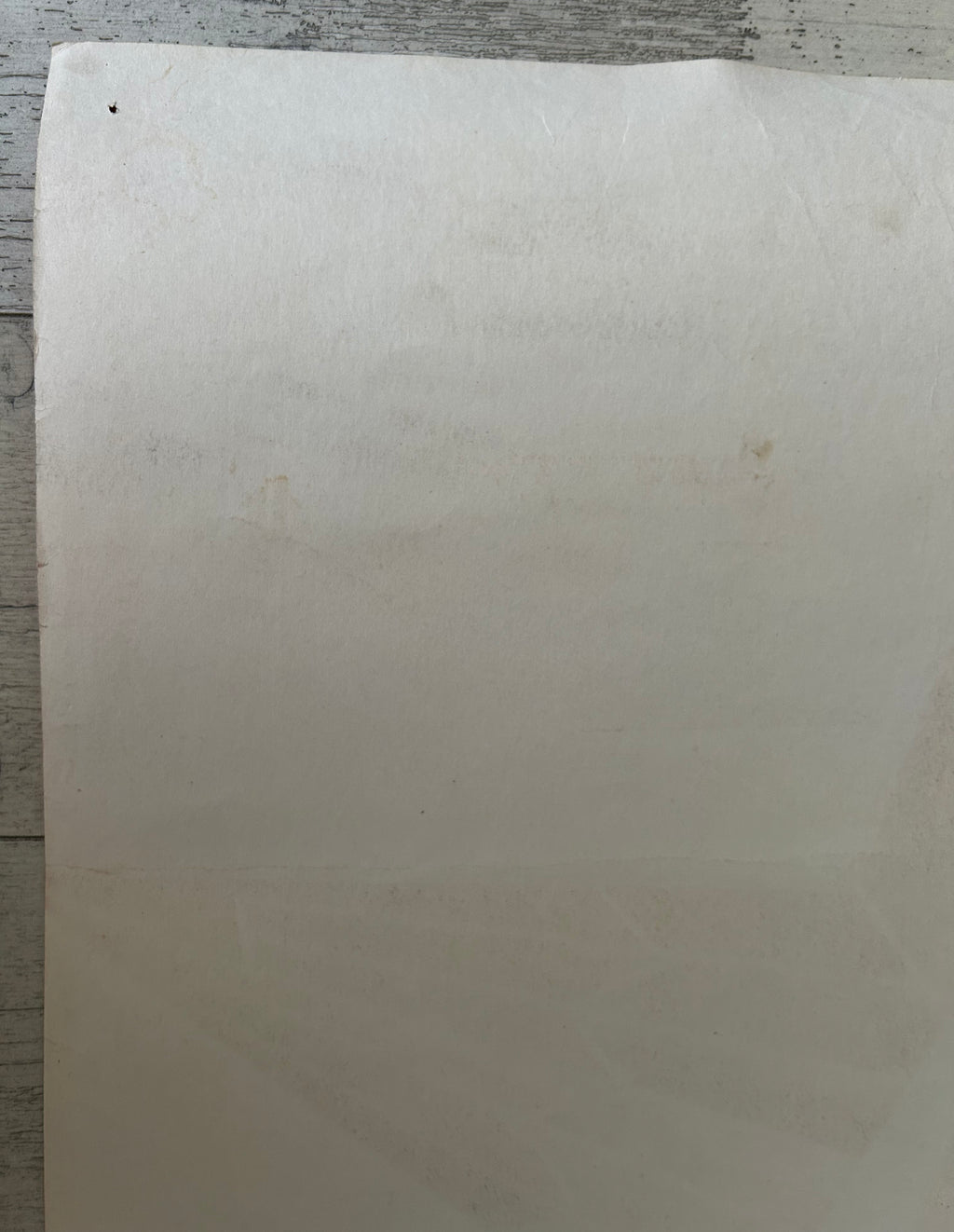 White sheet of paper on a wooden surface