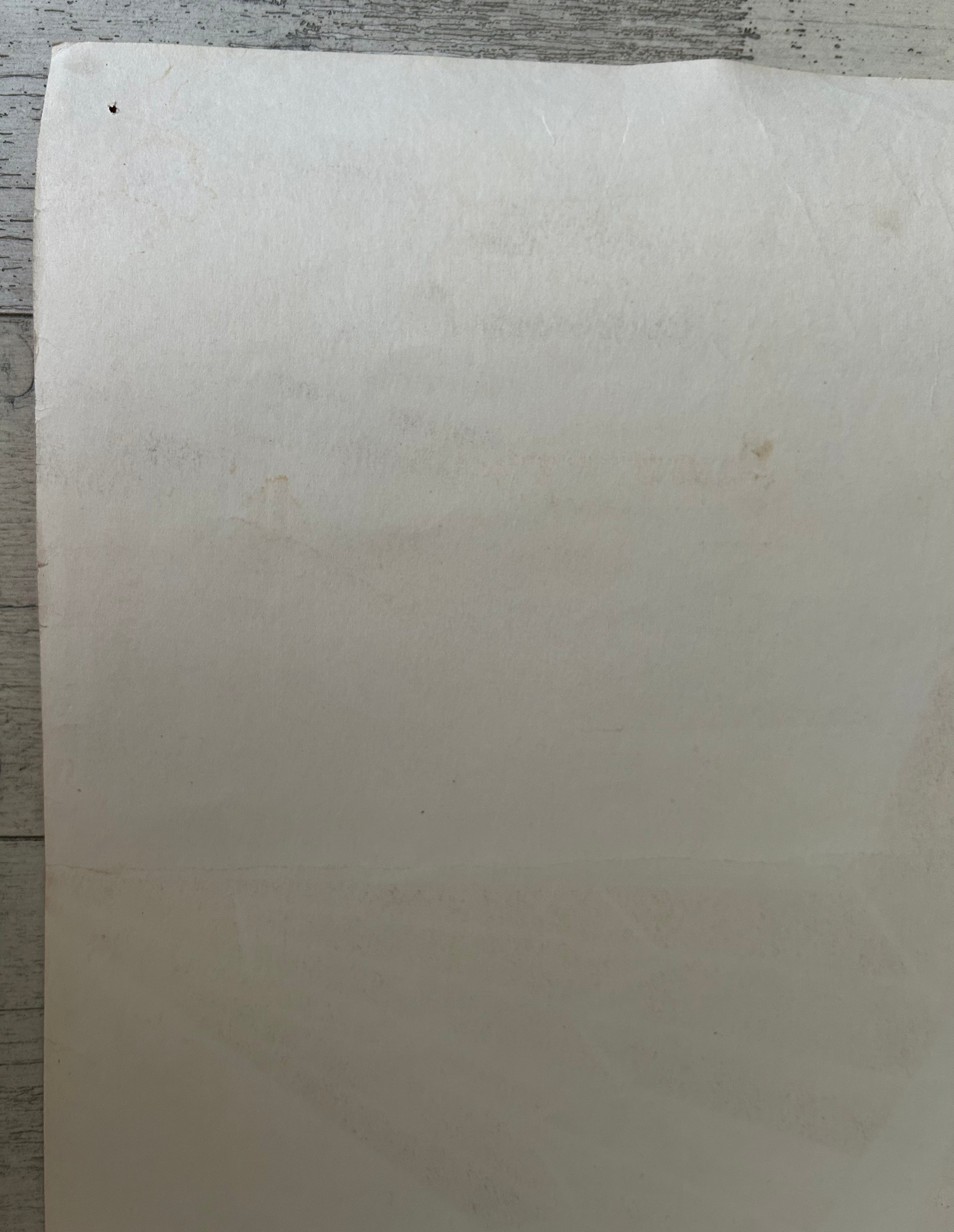 White sheet of paper on a wooden surface