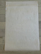 Beige paper sheet on a wooden surface