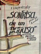 Theatrical poster for 'Sonrisa de un Payaso' with marionette strings and puppet design.