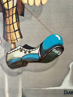 Close-up of a blue shoe with white laces on a gray background