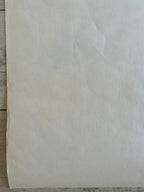 Beige paper on a wooden surface